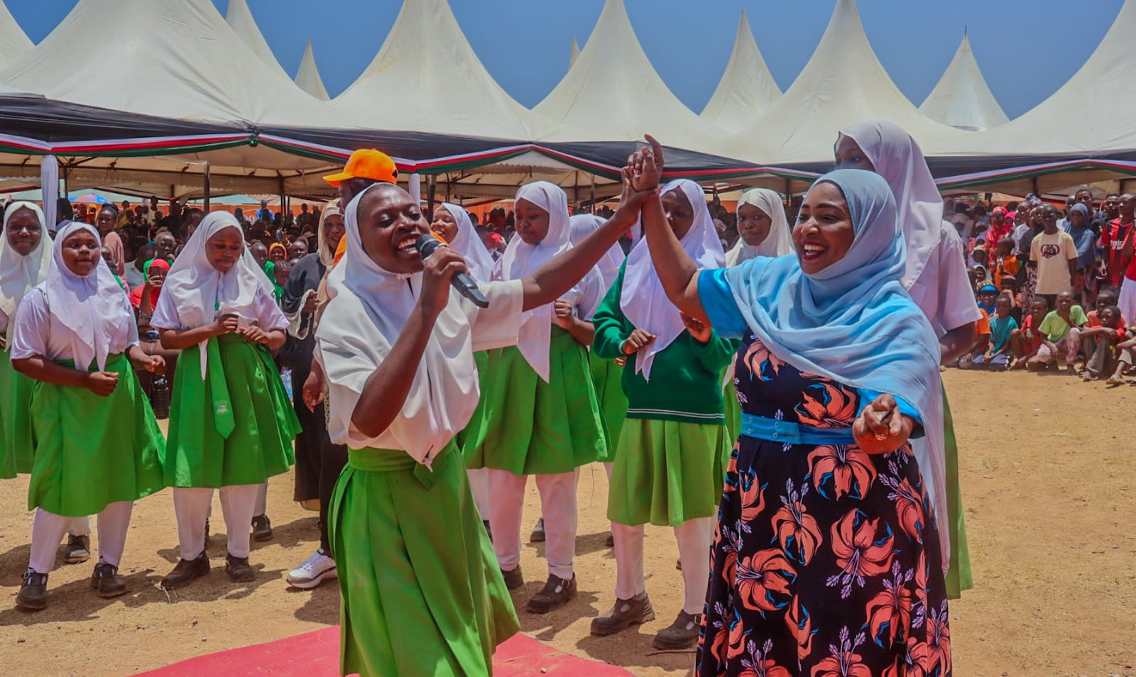 Foundation team sharing a joyful moment with schoolgirls during an outreach event